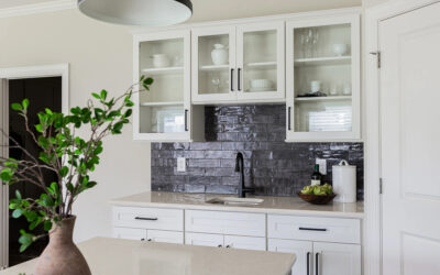 Textured black tiled backsplash with white cabinets