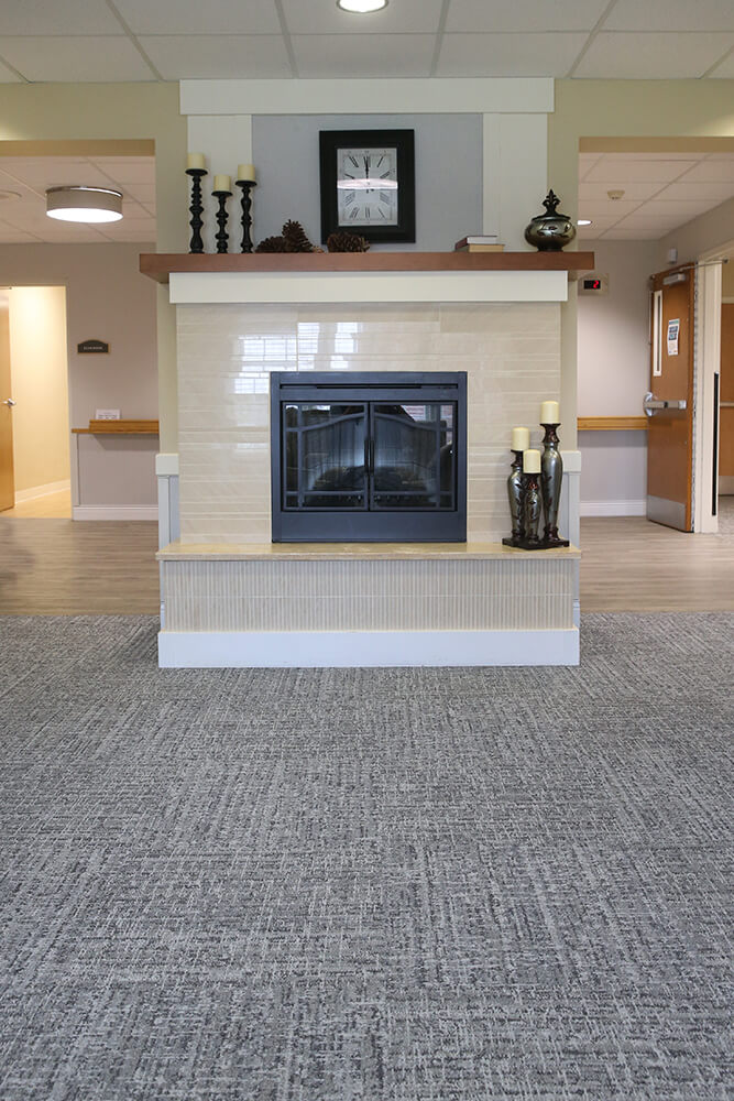 Fairmount Homes living area with fire place carpet installation from Martins Flooring